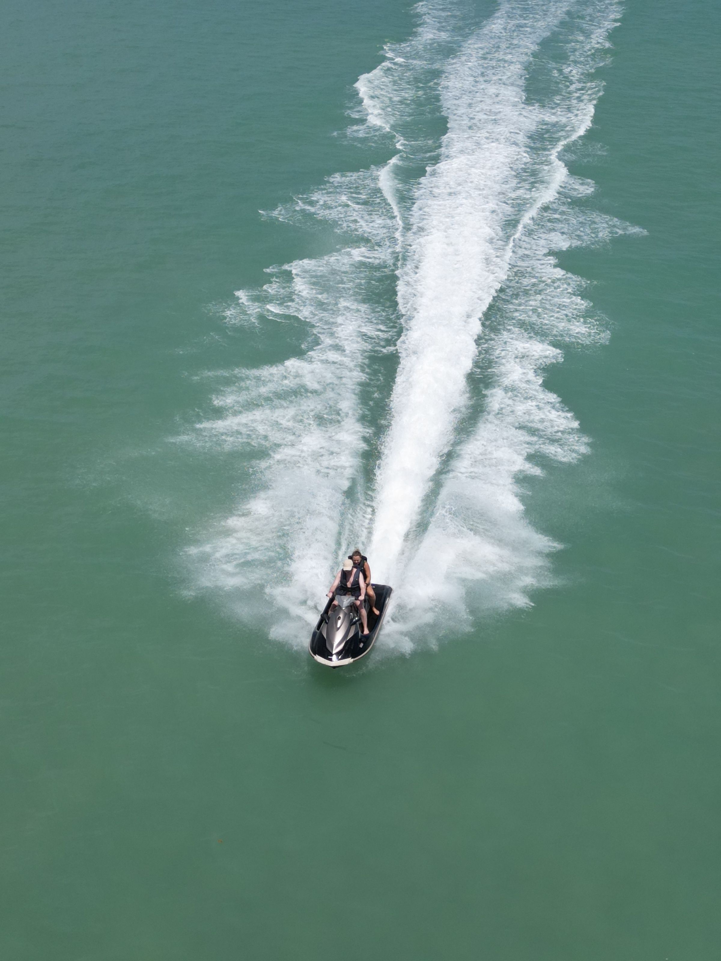 Jet ski crossing turquoise water